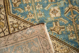Distressed aqua blue Hamadan rug pile revealing ivory Herati pattern and hand-knotted backing.