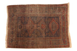 Antique Belouch carpet, elongated diamond medallions, geometric design, navy, red, brown, patina.
