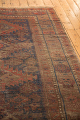 Antique Belouch rug showcasing mostly even wear, foundation showing through, and geometric floral motifs.