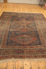 Antique Belouch carpet's lower border with worn navy and red geometric motifs, natural fringe.