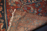 Coarse woven foundation and tattered fringe of an antique Hamadan rug.