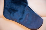 Cobalt navy velvet stocking's textured fabric, highlighting its soft sheen.