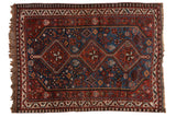 Afshar rug: triple sapphire blue medallions, rust red field of geometric animal, pinwheel motifs.