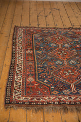 Vintage Afshar rug: geometric floral patterns, rust red border, and sapphire blue field.