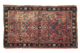 Antique Kerman rug with sprawling vinery, cochineal red field, and navy border, 2'11