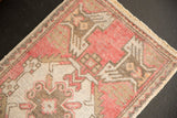 Distressed raspberry red and ivory Oushak rug pile with faint foundation and secured side.
