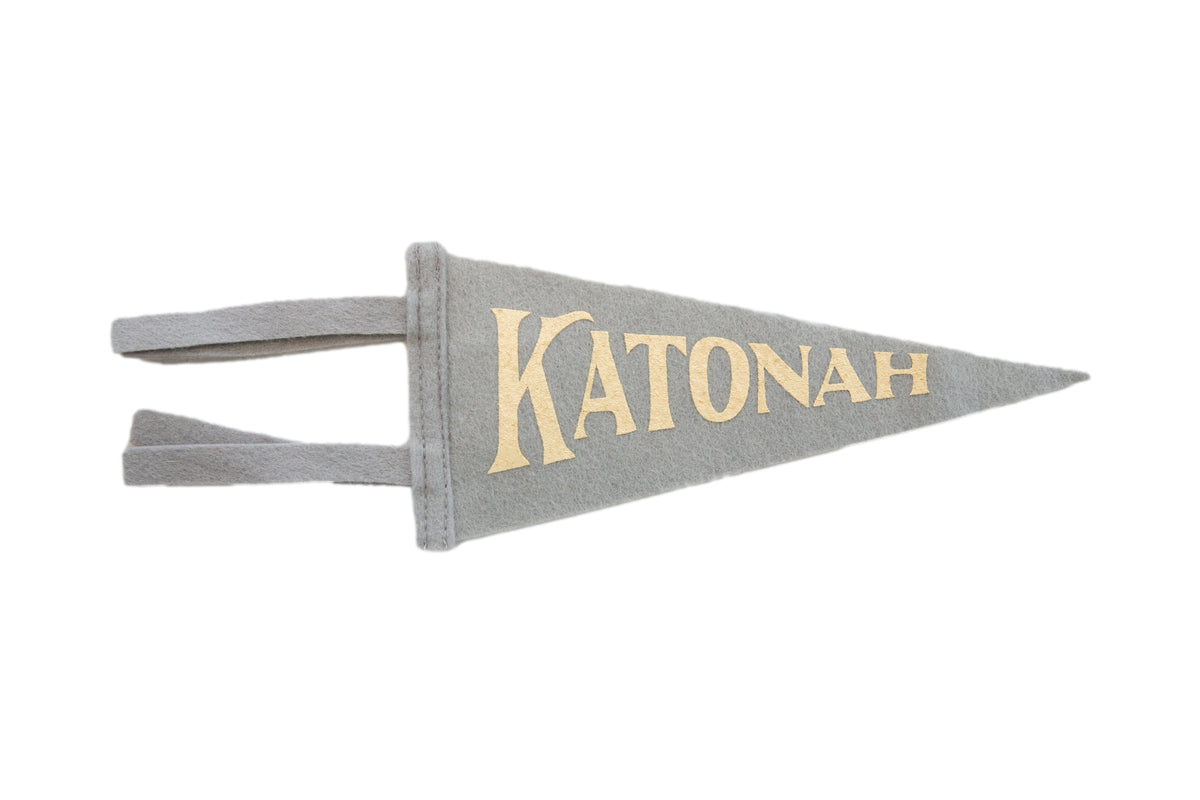 A grey wool felt mini pennant with "Katonah" in gold vintage lettering.