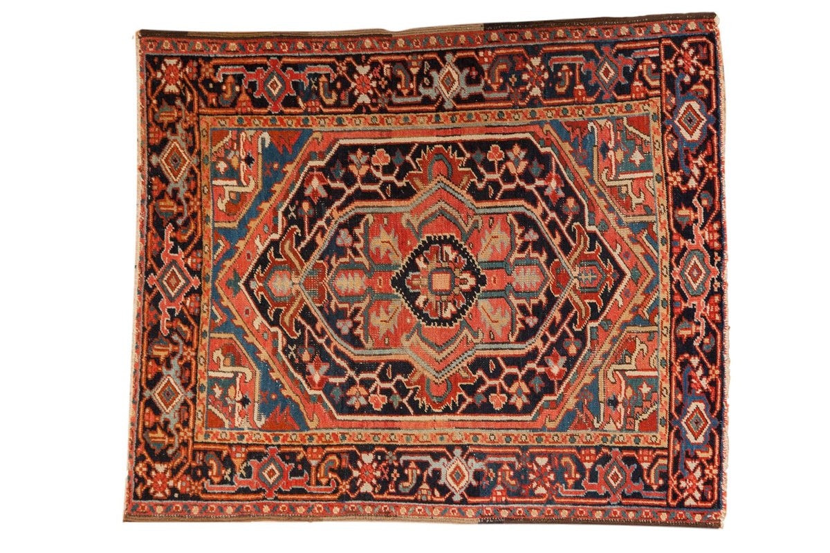 Vintage Heriz rug with a large navy and red lozenge medallion surrounded by a classic turtle samovar border.
