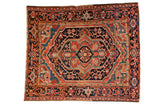 Vintage Heriz rug with a large navy and red lozenge medallion surrounded by a classic turtle samovar border.