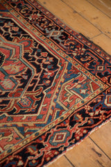Angled view of the vintage Heriz rug's corner, highlighting the classic turtle samovar border.