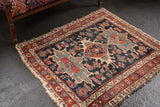 Antique Karaja rug detail with asymmetric medallion, crab-like motifs, starbursts in navy, red, ivory.
