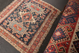 Antique Karaja rug corner with tattered fringe and detailed geometric border design.