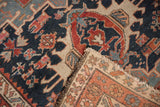 Hand-knotted antique Karaja rug corner, crab-like motifs, tattered edge, navy, red, ivory tones.