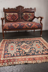 Antique Karaja rug detail: navy blue field, wine red border, geometric motifs, and tattered fringe.