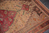 Delicate floral vines on the antique ivory field with a cherry red Farahan Sarouk medallion.