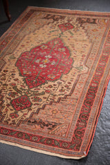 Low pile vintage Farahan Sarouk rug detail: dark cherry red borders, ivory floral field.