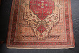 Bottom right corner of vintage Farahan Sarouk rug, cherry red floral border, ivory fringe.