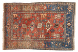 Vintage Persian Bijar rug: cherry red Harshang motif, navy samovar border, dramatic abrashes.