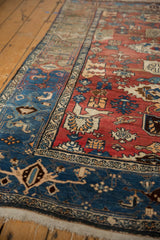 Red Harshang field and navy blue border with samovar turtle motif on vintage Bijar rug.