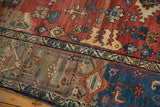 Vintage Bijar rug close-up: red Harshang field, green samovar turtle motif border.