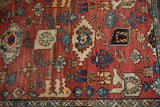 Vintage Bijar rug's dramatic abrashes, cherry red field, and blue samovar border motifs.