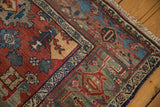 Vintage Bijar rug corner: red Harshang floral field, teal patterns, samovar turtle border, and abrashes.