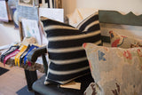 Angled close-up of Black and Khaki Throw Pillow, showing its horizontal pattern and fine fabric.