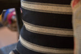 Black and khaki striped throw pillow fabric showcasing its herringbone weave.