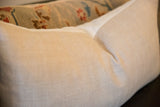 Herringbone pattern and neutral color of the linen lumbar pillow's fabric.