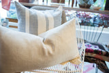 Neutral linen lumbar pillow with a subtle herringbone weave texture.