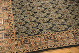 Distressed vintage Oushak rug with geometric pale terra cotta border, worn black motifs.