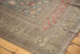 Distressed Oushak corner with faded raspberry and pale bronze intricate floral motifs.