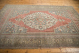 Distressed vintage Oushak carpet with faded raspberry blush and silver-grey tones.