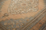 Distressed Oushak rug corner with slate grey blue border and sandalwood medallion detail.