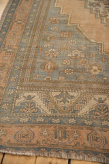 Muted slate blue Oushak rug detail, apricot floral motifs, sandalwood spandrel, and low pile.
