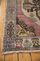 Vintage Oushak rug runner corner with distressed texture, mauve, lupine blue geometric border and fringe.