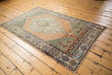 Distressed Oushak rug with even wear, apricot field, and playful floral palmettes.