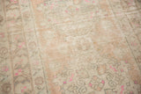 Distressed Oushak rug pile with mostly even wear, antique ivory, pale peach, and bright pink.