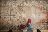 Mid-section of distressed Oushak runner revealing tonal beige, rust, and brown patterns.