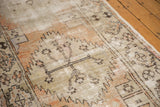 Distressed vintage Oushak runner with exposed foundation, geometric patterns, and terra cotta tones.