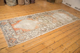 Distressed Oushak runner's worn pile texture, revealing pale terra cotta and foundation.