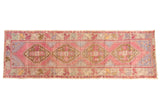 Vintage Distressed Oushak rug runner with rose, bronze geometric medallions, and floral border, 3' x 9'4
