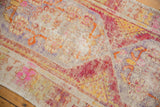 Distressed Oushak runner pile detail with playful pink, orange, yellow floral motifs.