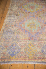 Distressed vintage Oushak runner with soft mauve, pale green, gold geometric motifs and visible knot wear.