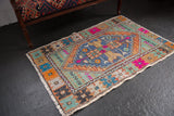 Distressed vintage Oushak rug with a multi-color diamond medallion and curvilinear motifs, 2'10