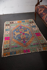 Vintage distressed Oushak rug corner showing faint foundation through worn pile.