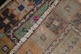 Distressed Oushak rug pile with vibrant pink accents, fringe, and visible hand-knotted foundation.