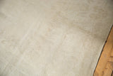 Distressed vintage Oushak rug pile texture with foundation visible, in soft beige and ivory tones.