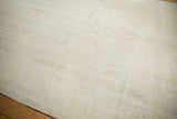 Faint Rococo patterns and light ivory tones with even wear on a distressed Oushak carpet.
