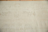 Distressed vintage Oushak carpet pile with faint tone-on-tone Rococo patterns and visible foundation.